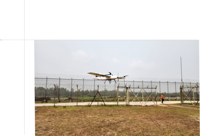 A drone flying over a barricaded field