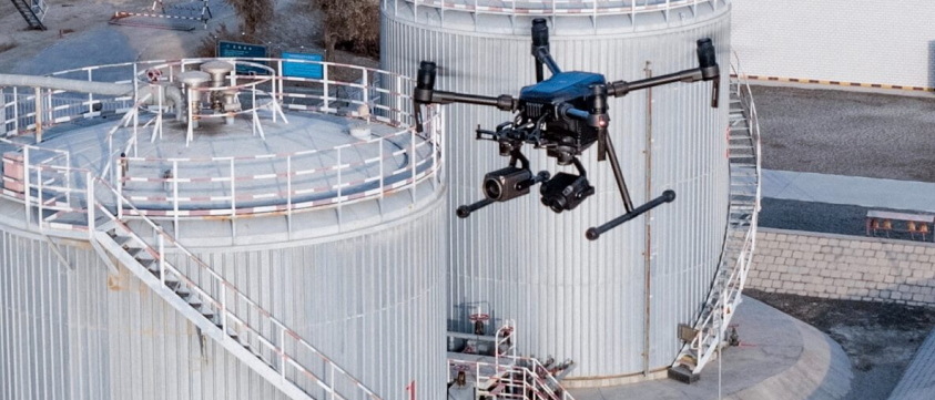 A drone flying over an oil and gas rig